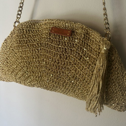 Handmade knitted shoulder bag in gold with decorative tassel