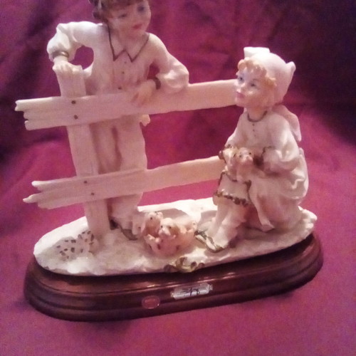 Decorative children with dogs gypsum on wood used