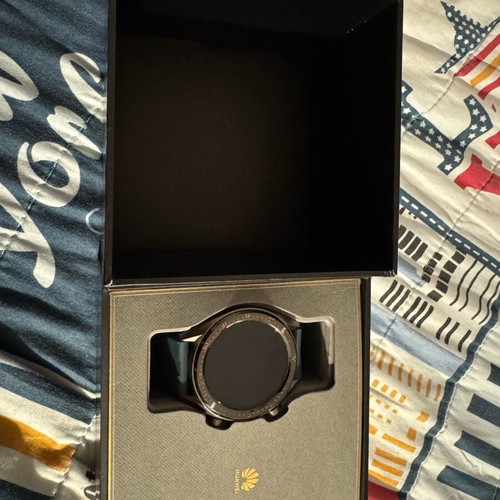 Huawei GT smartwatch used with charging base and fabric straps
