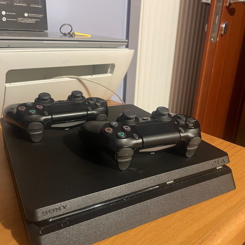 PS4 Slim console with 2 controllers and games