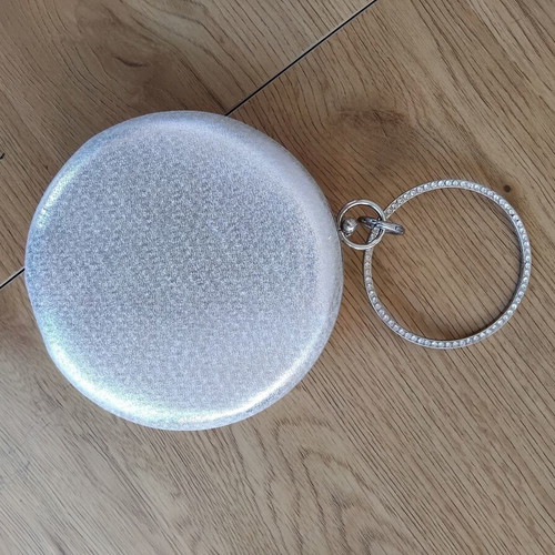 Round silver evening clutch bag with rhinestone ring handle used