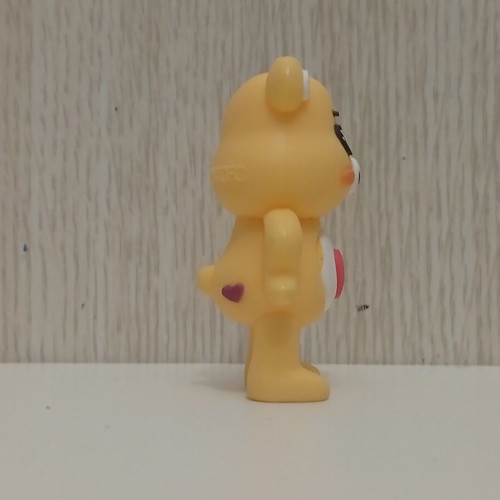 Care Bears Yellow Love-A-Lot Bear figure used with red heart