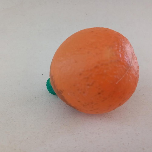 Plastic orange-shaped bottle used for beverage