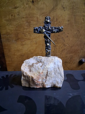 Cross sculpture used made of rings and nails