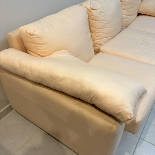 Three-seater fabric sofa used, light pink-peach color with side cushions