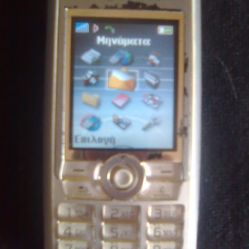 Sony Ericsson K700i used mobile phone with charger and headphones