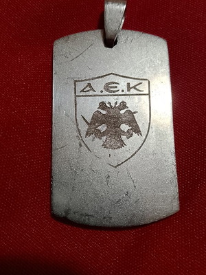 AEK stainless steel pendant with engraved emblem, like new