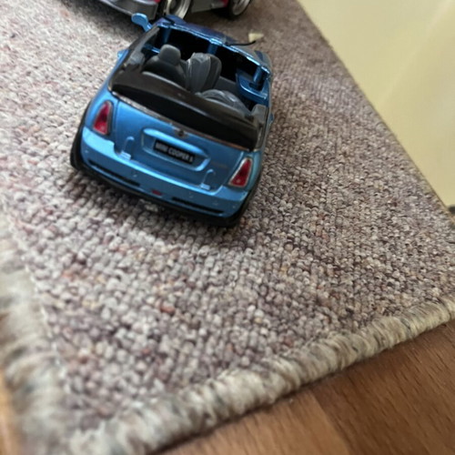 Toy cars, some unused, plastic and metal Mini Cooper