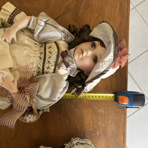 Porcelain doll with hat and basket, 52 cm