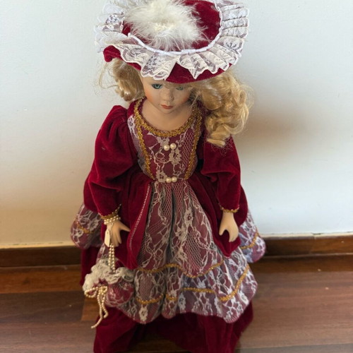 Porcelain doll with burgundy velvet dress like new