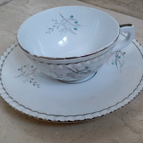 Single porcelain breakfast cup like new with blue flower and silver detail by Minoan Ceramics