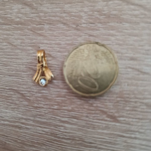 Gold-colored pendant with white stone used, vintage style