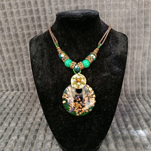 Necklace with green beads and glass pendant used