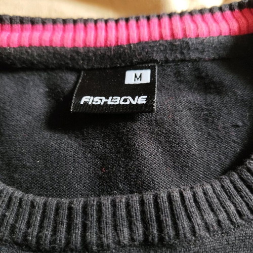 Black sweater used, medium size with loose fit and small hole