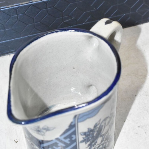 Vintage ceramic jug blue and white with bird and floral motifs used