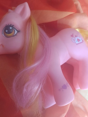 Large pink pony toy with colorful mane and tail