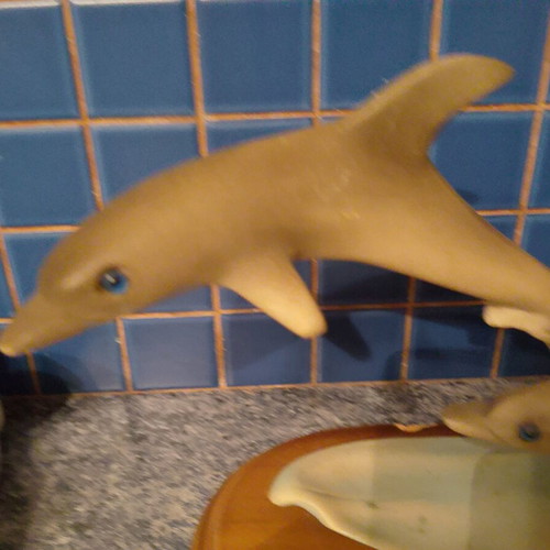 Vintage retro dolphin sculpture with wooden base used