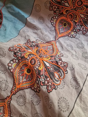 Throw from India used with hand-stitched colorful animal motifs