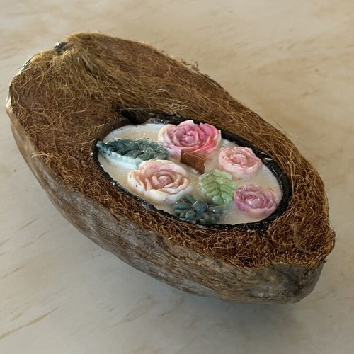 Handmade candle in natural coconut shell