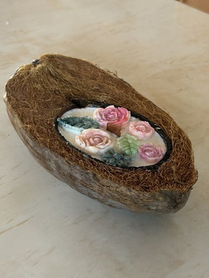 Handmade candle in natural coconut shell