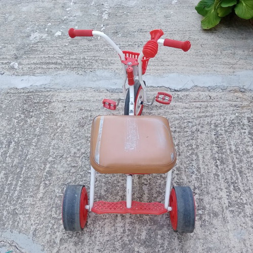 Red children's tricycle with extra foam seat
