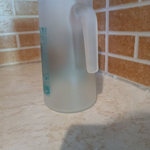 Glass pitcher with butterfly design like new