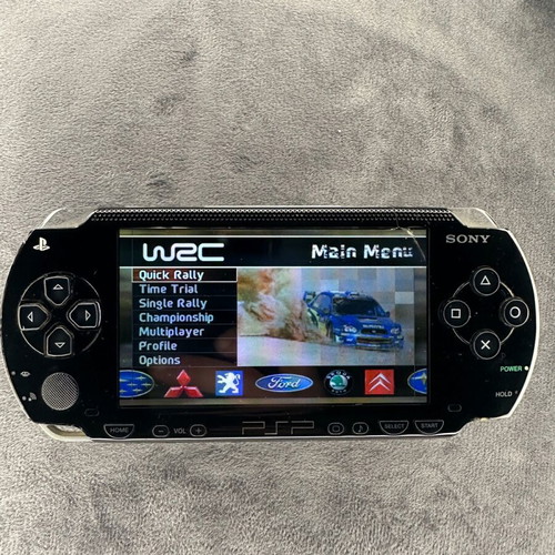PlayStation Portable PSP-1000 used with charger, 5 games, and Memory Stick