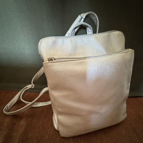 Backpack like new gray silver leatherette with three zippers