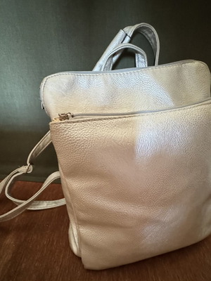 Backpack like new gray silver leatherette with three zippers