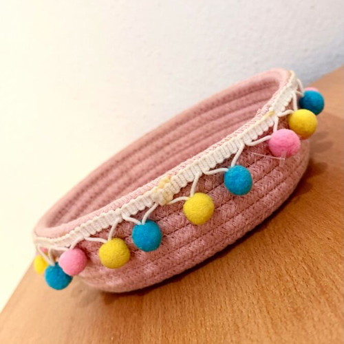 Handmade pink basket with colorful pom poms like new