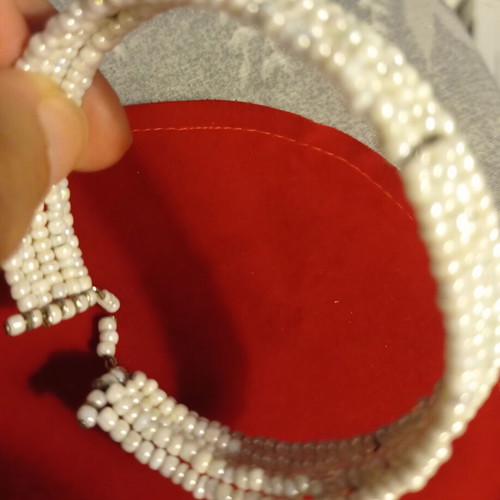Vintage bracelet used with multiple rows of tiny white beads