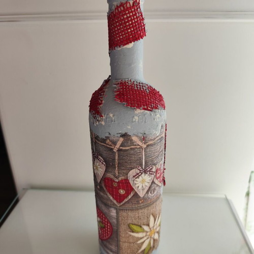Glass bottle new with decoupage decoration and red hearts