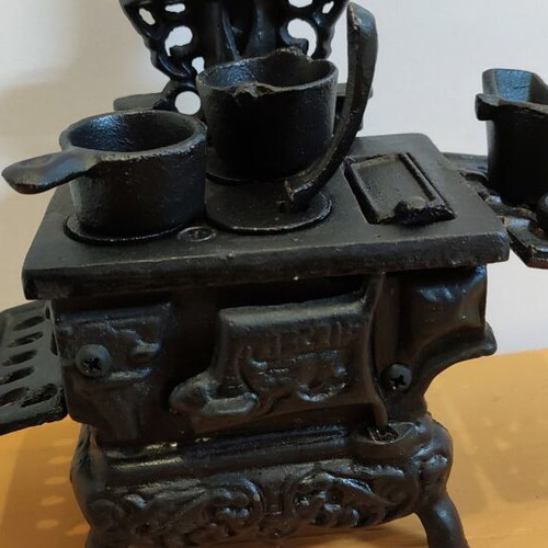 Miniature wooden stove with cast iron accessories like new
