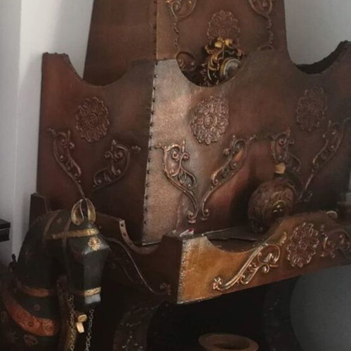 Decorative fireplace set with table and copper wall plaque