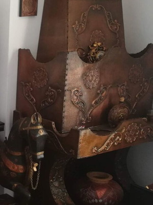 Decorative fireplace set with table and copper wall plaque