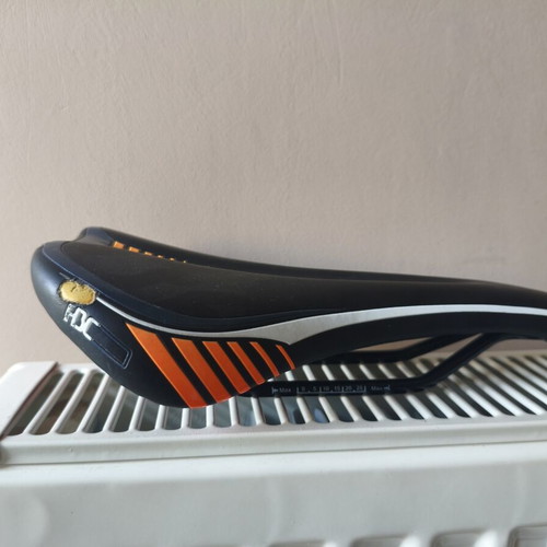Bicycle saddle for MTB used, 300 grams, slight tear on right side