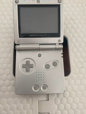 Nintendo Game Boy Advance SP console used with game and charger