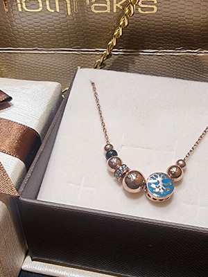 Silver tree of life necklace with pink gold plating and warm enamel