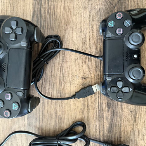 PlayStation 4 Slim 500GB used with 2 DualShock 4 controllers and accessories