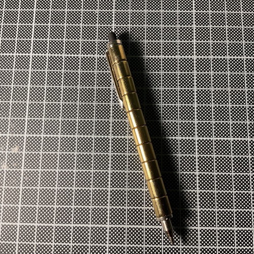 Gold Fidget Pen used with magnetic parts and two ink refills