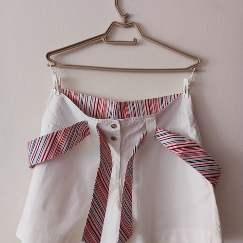Red sleeveless blouse like new with white shorts and striped belt