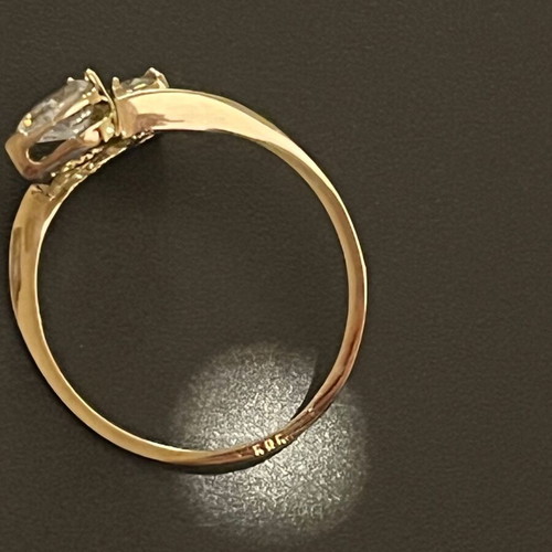 Women's 14K gold ring like new with round cut and pear-shape stones