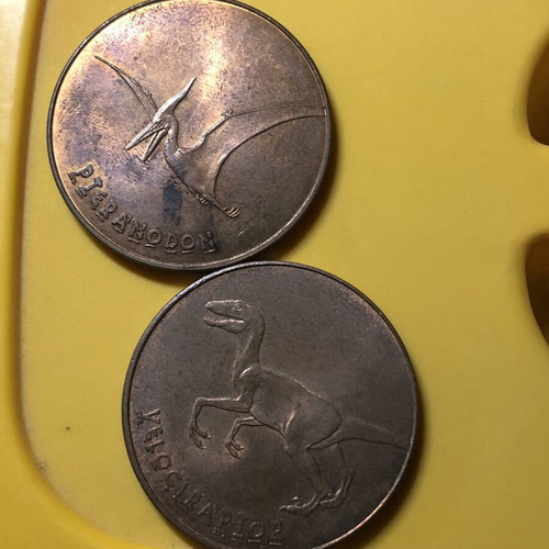 Jurassic World Tetley Velociraptor and Pteranodon coins, 38mm