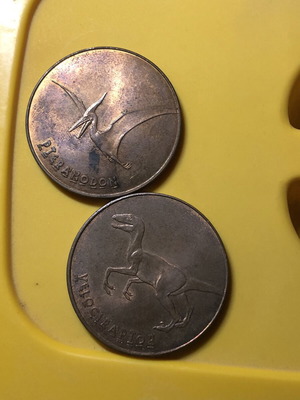 Jurassic World Tetley Velociraptor and Pteranodon coins, 38mm