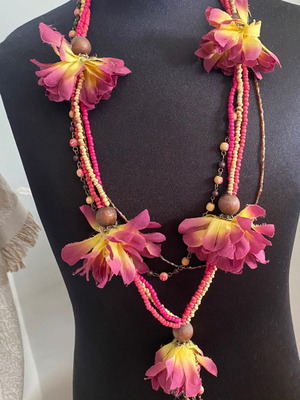 Necklace with beads and fabric flowers used