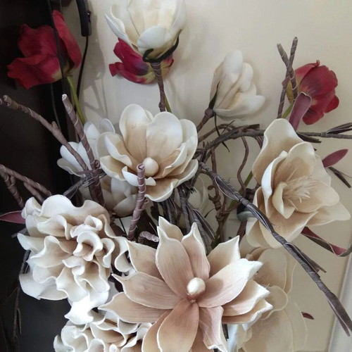 Decorative floral arrangement with large earth-tone flowers