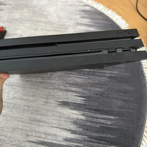 Sony PlayStation 4 Pro 1TB console used with controllers and charging dock