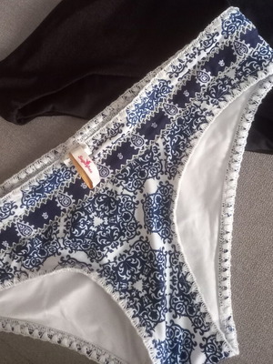 Sugarfree swim brief with white-blue ethnic pattern, size Large, plus free black swim brief