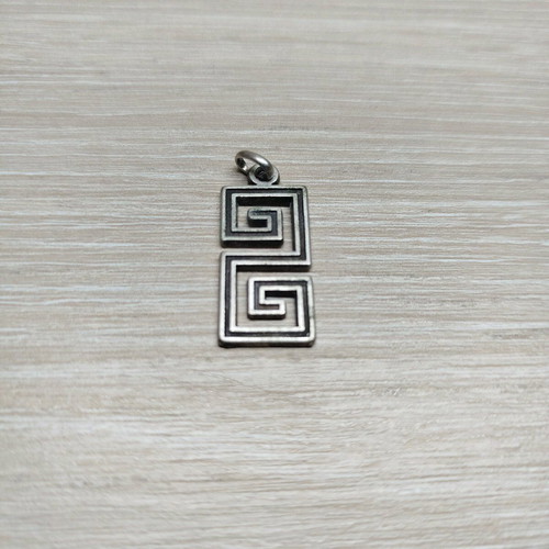 Pendant with double Meander like new, silver color