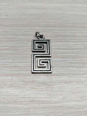 Pendant with double Meander like new, silver color